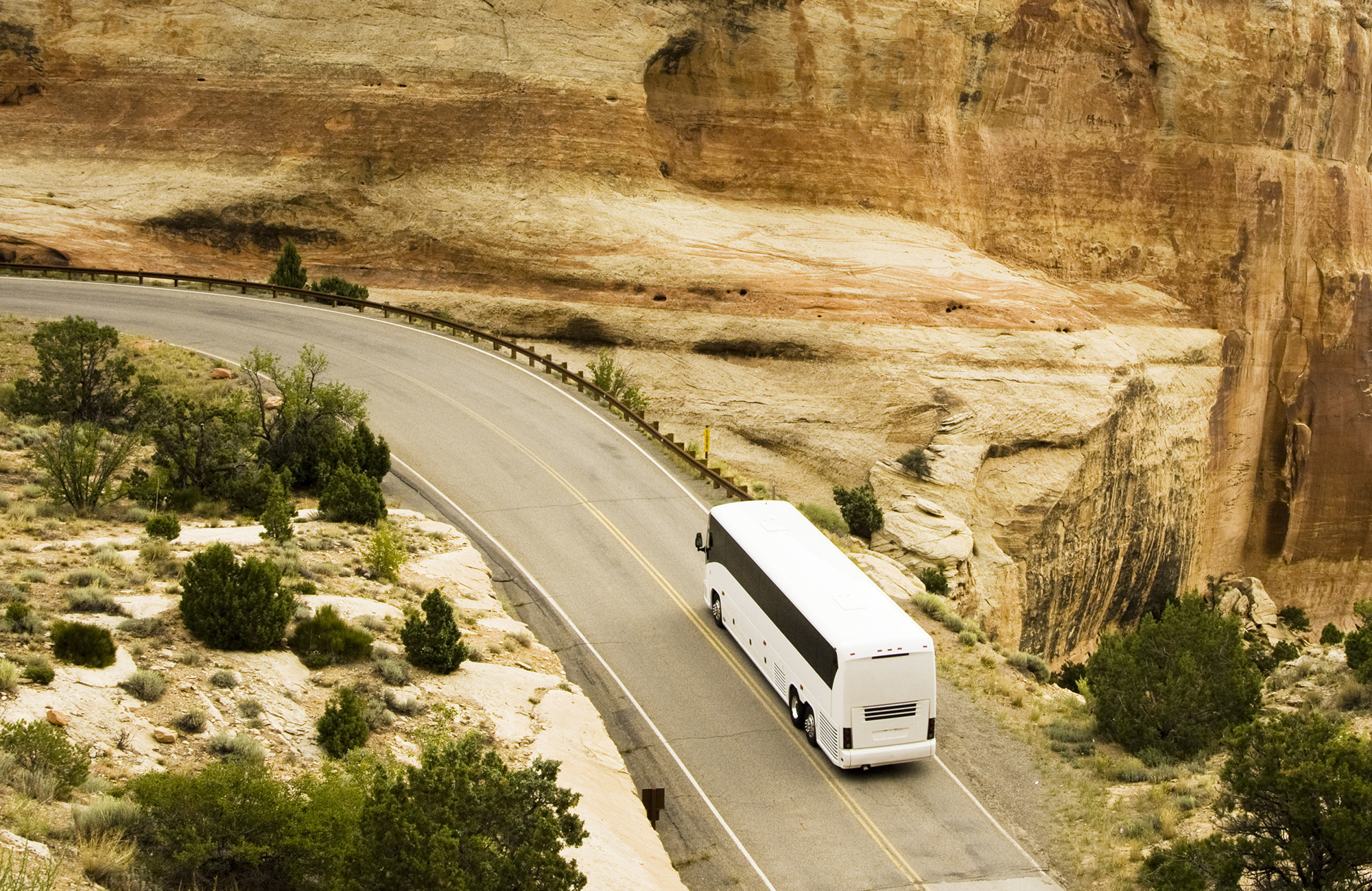 bus-driving-in-scenic-area-aerial-cover
