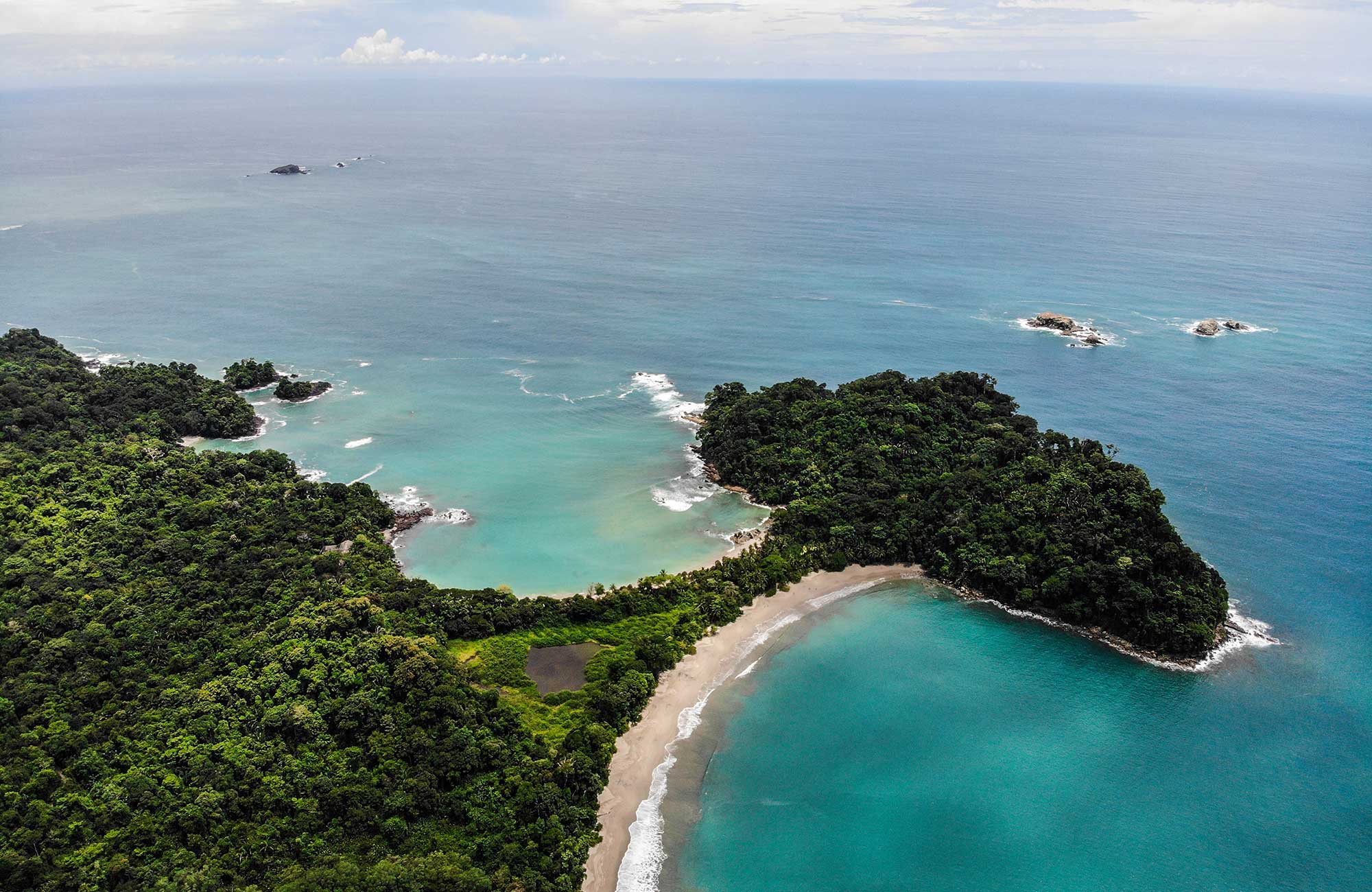 Manuel Antonio national park and its gorgeous sandy beaches viewed from above.