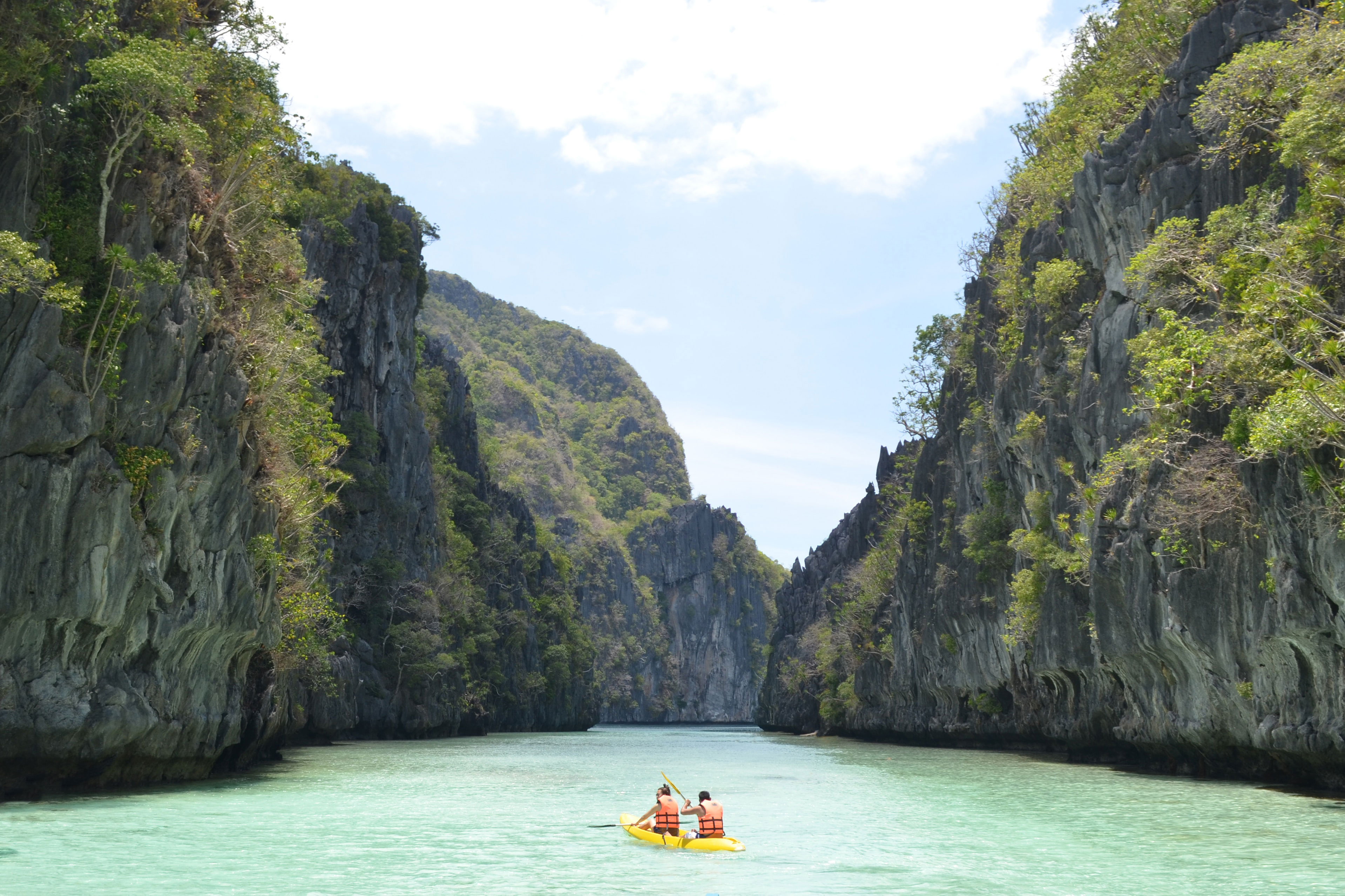Kayak With Two Travellers In A Really Clear Bay On El Nido In The Philippines