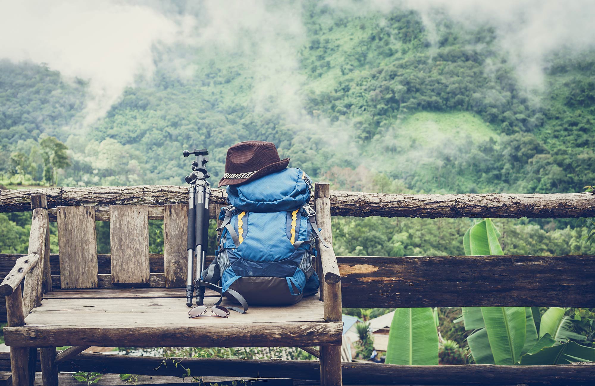 backpack-wooden-bench-view-planning-costs-before-trip-cover