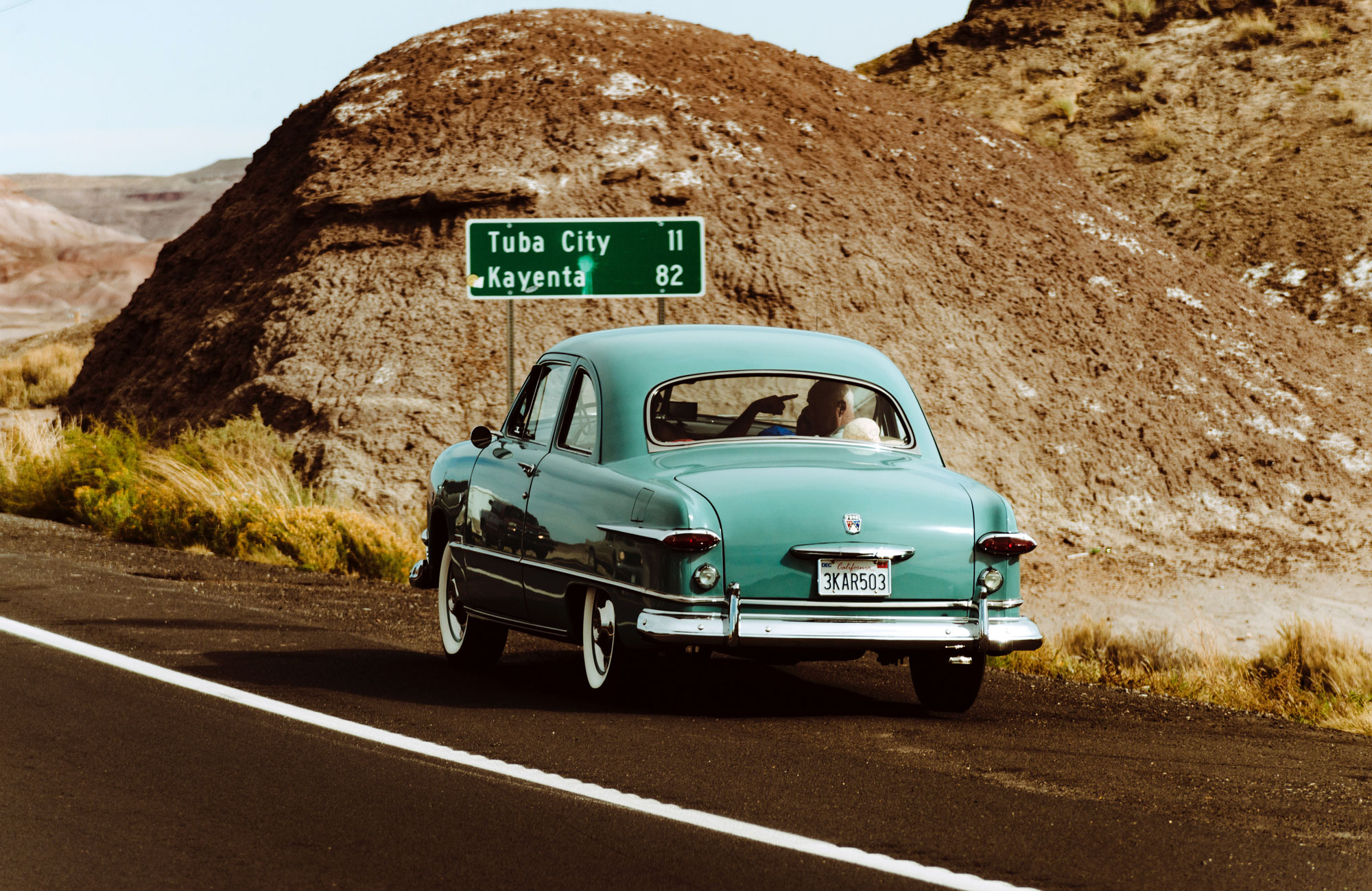 Lightblue Oldtimer Car By The Side Of The Road In A Desert Landscape In The USA
