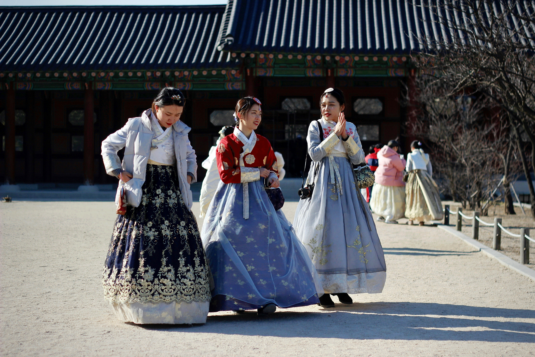 Three Girls In Traditional South Korean Dresses At Gyeongbokgung Palace In Seoul